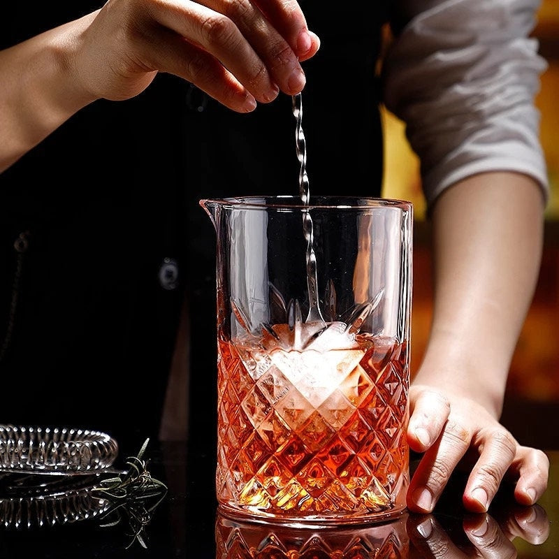 Clear faceted cocktail mixing glass with pour spout